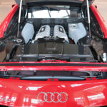 An Audi with the hood open showcasing the engine on Auto Smart showroom floor