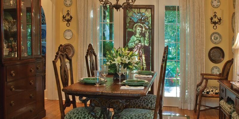 dining room table with custom green leopard print upholstery on chairs