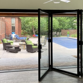 custom bi-fold door with patio and pool in the background